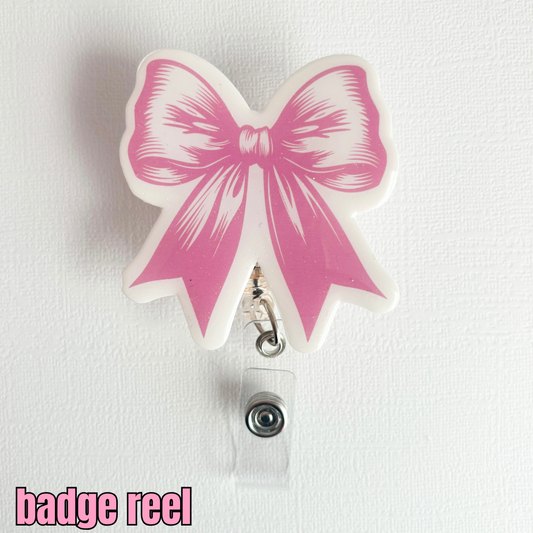 coquette, bow badge reel